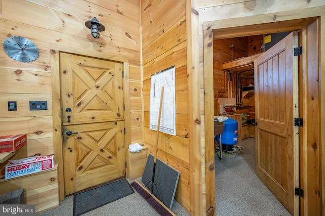 entryway with wood walls and carpet