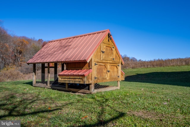 view of outbuilding featuring a lawn