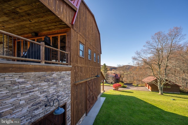 view of side of home featuring a lawn and a mountain view