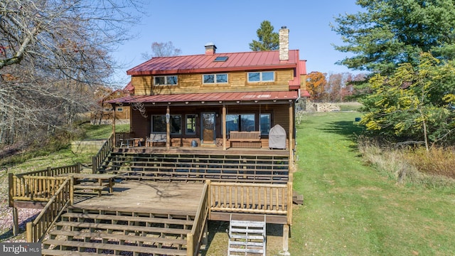 view of front of house with a front lawn and a wooden deck