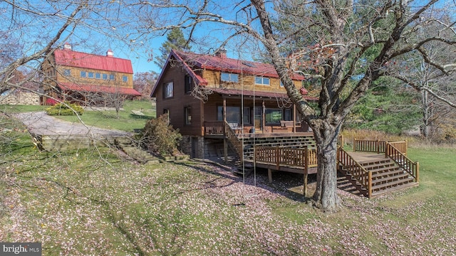 back of house featuring a yard and a deck