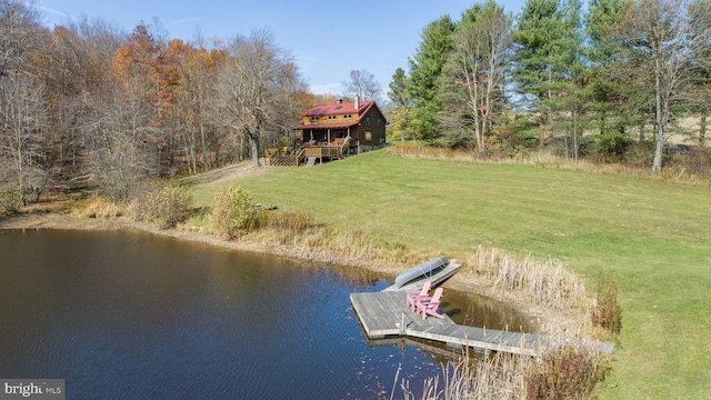 dock area with a lawn and a water view