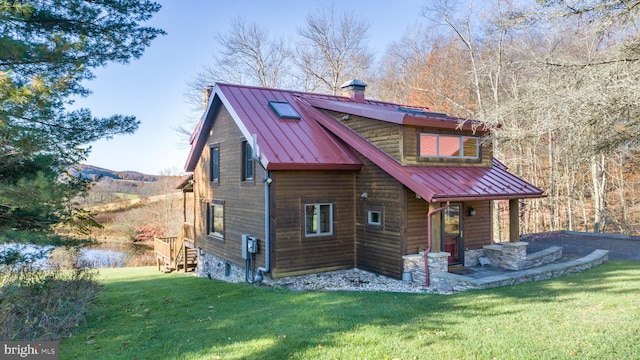 back of house with a lawn