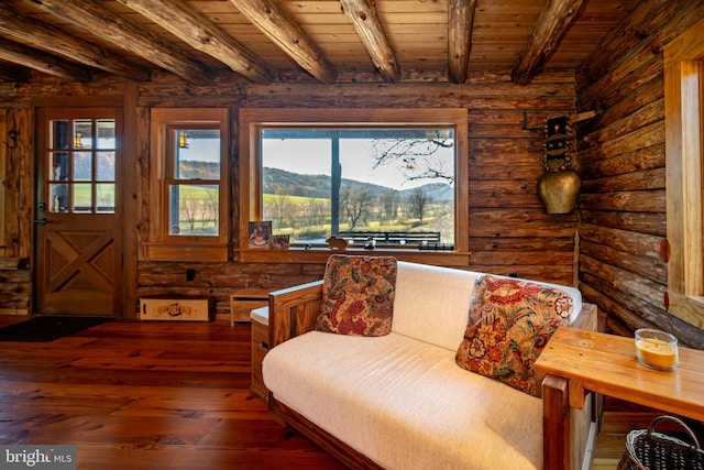 sitting room featuring beamed ceiling, wooden ceiling, dark hardwood / wood-style floors, and a mountain view