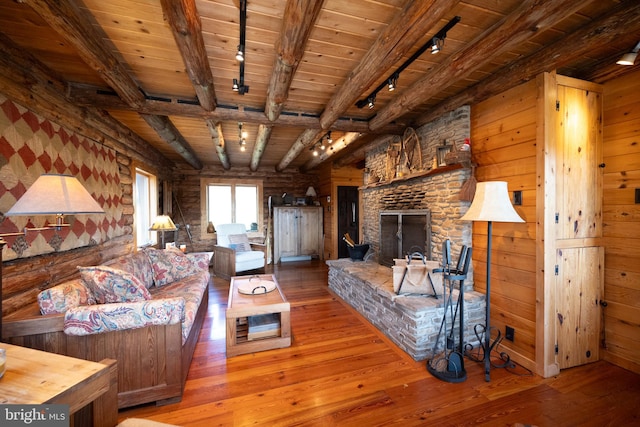 living room featuring wooden ceiling, beamed ceiling, and light hardwood / wood-style flooring