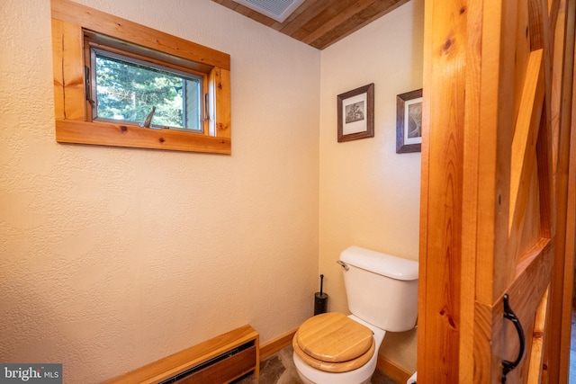 bathroom with a baseboard radiator and toilet