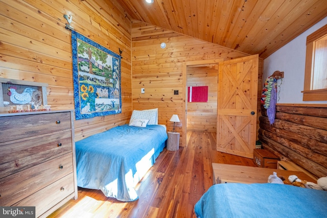 bedroom with lofted ceiling, wooden ceiling, and wood-type flooring