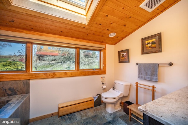 bathroom with toilet, vaulted ceiling with skylight, and wooden ceiling