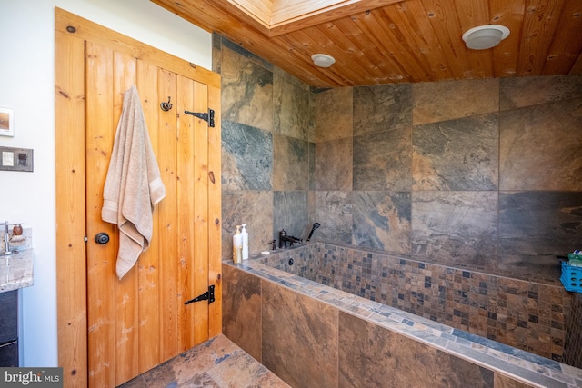 bathroom with a tub to relax in and wood ceiling