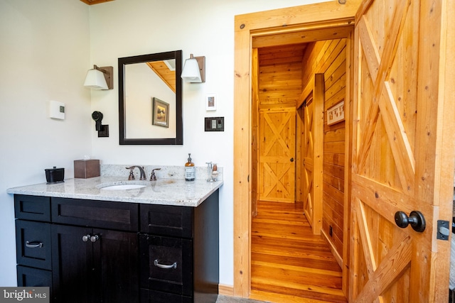 bathroom with hardwood / wood-style flooring and vanity