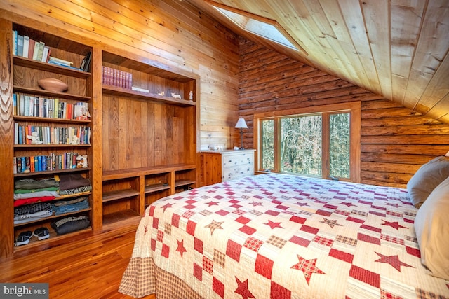 bedroom with wood walls, vaulted ceiling with skylight, hardwood / wood-style flooring, and wooden ceiling