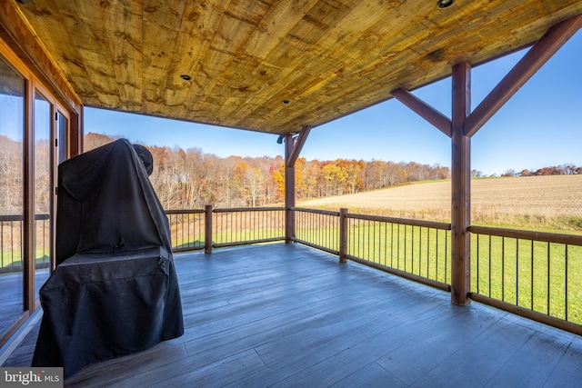 wooden deck featuring a lawn