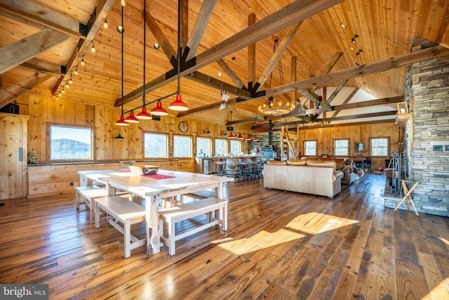 unfurnished dining area featuring dark wood-type flooring, wood ceiling, and high vaulted ceiling