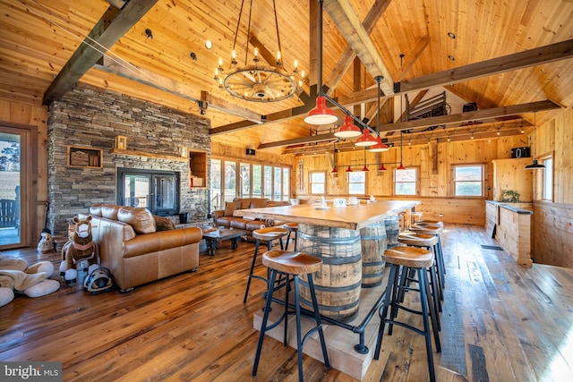 kitchen featuring wooden counters, hardwood / wood-style flooring, wooden walls, and decorative light fixtures