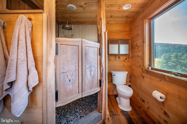 bathroom with hardwood / wood-style floors, wood ceiling, toilet, and wooden walls