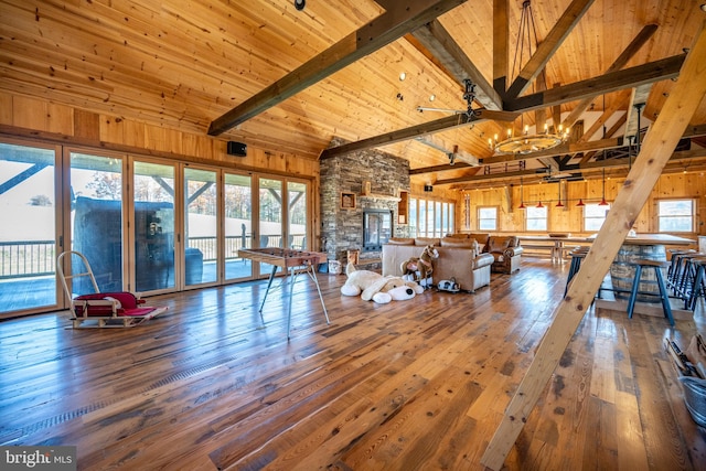 unfurnished living room with wood-type flooring, plenty of natural light, and high vaulted ceiling