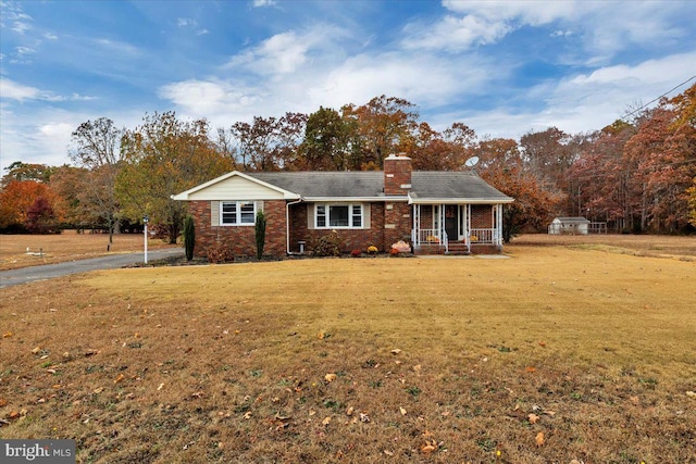 ranch-style home with covered porch and a front lawn