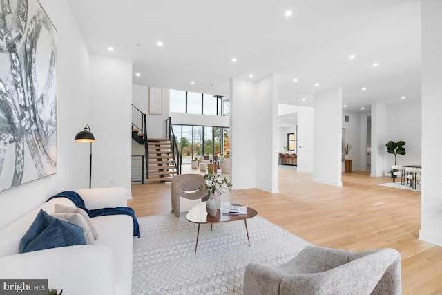 living room featuring a high ceiling and light wood-type flooring