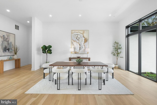 dining room with light wood-type flooring and plenty of natural light