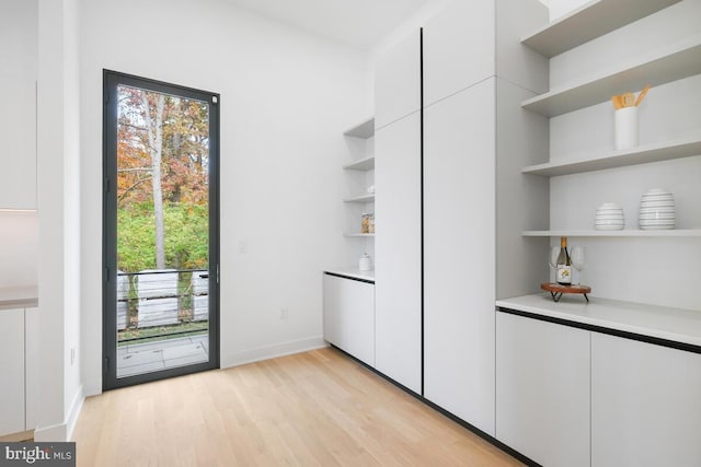 interior space with white cabinets and light hardwood / wood-style floors