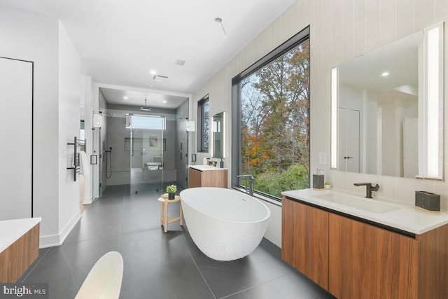 bathroom with plenty of natural light, vanity, and independent shower and bath