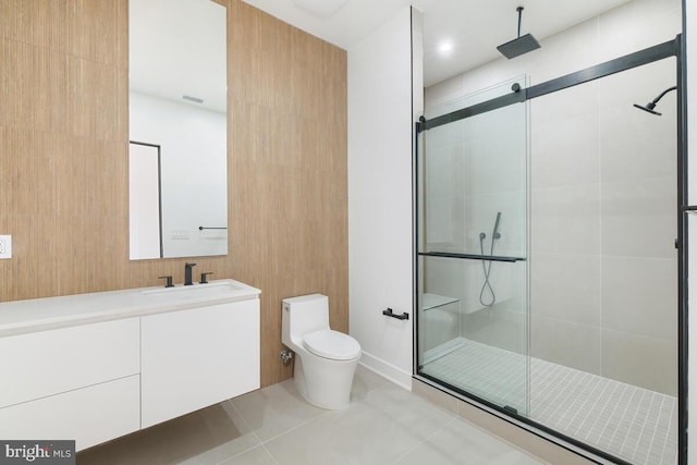 bathroom featuring vanity, a shower with shower door, tile patterned flooring, and toilet