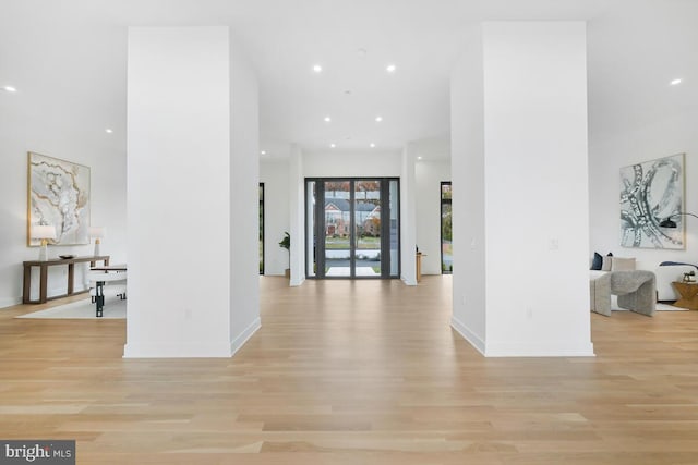 corridor with light hardwood / wood-style floors