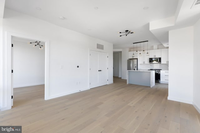 30 Kennedy St NW Unit 12, Washington, DC 20011 - unfurnished living room featuring baseboards, visible vents, and light wood-style floors