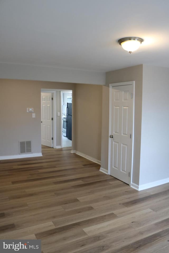 empty room with wood-type flooring