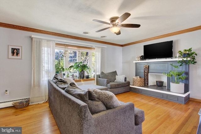 living room with ceiling fan, a baseboard heating unit, light wood-type flooring, and crown molding