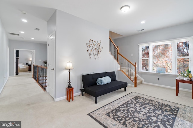 sitting room featuring light carpet