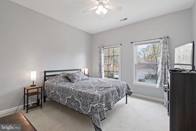 bedroom with light colored carpet and ceiling fan