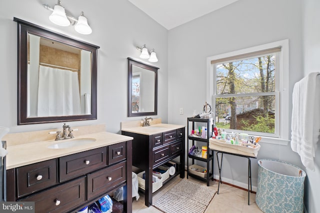 bathroom with vanity, tile patterned floors, and curtained shower