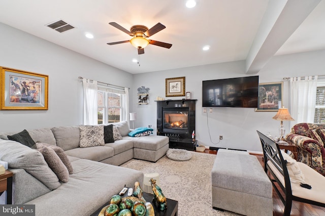 living room featuring wood-type flooring and ceiling fan