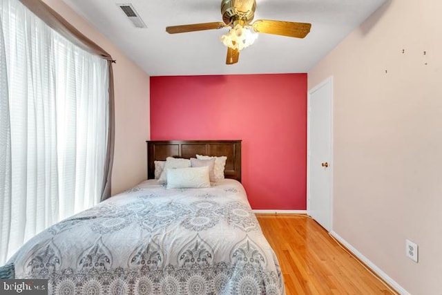 bedroom with hardwood / wood-style flooring and ceiling fan