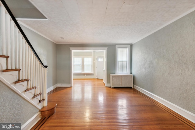 entrance foyer featuring light hardwood / wood-style flooring, radiator heating unit, and a textured ceiling