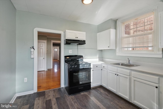 kitchen with dark wood-type flooring, gas stove, sink, and white cabinets