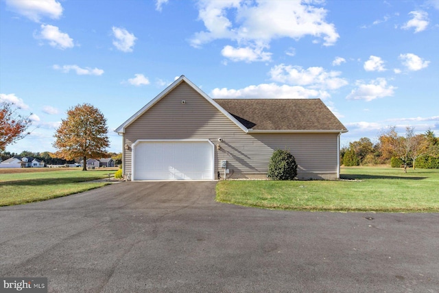 view of front of house featuring a front yard and a garage