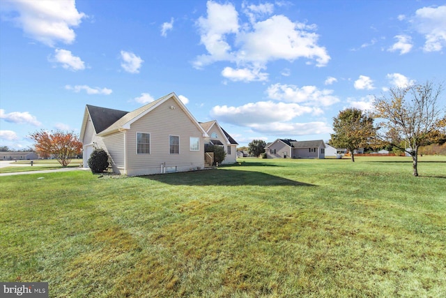 view of side of home with a lawn