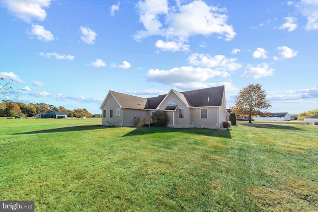 back of property featuring a lawn