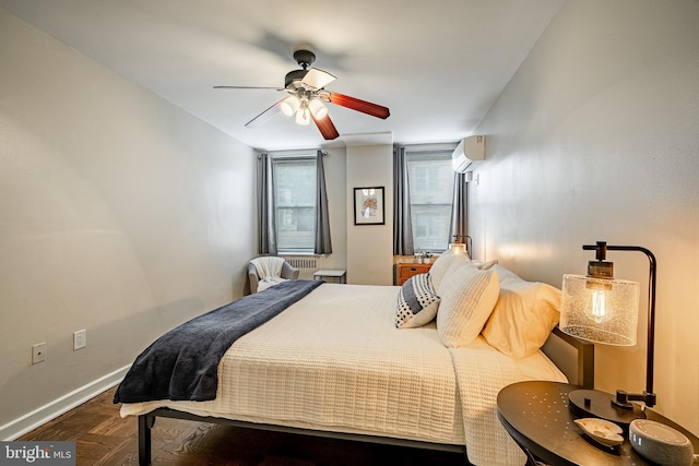 bedroom featuring dark parquet flooring, ceiling fan, and a wall mounted AC