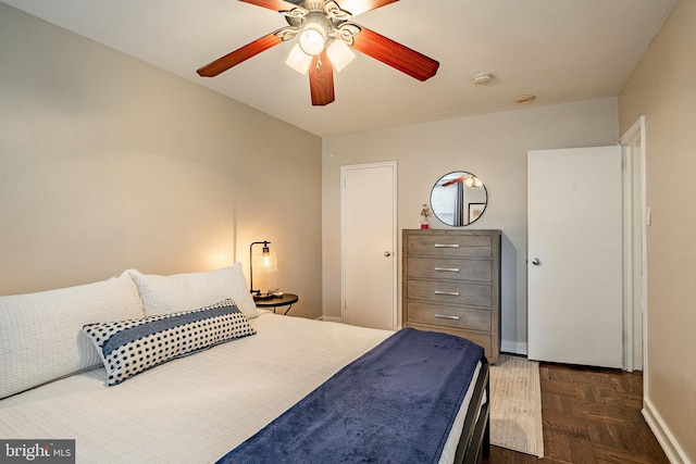 bedroom featuring dark parquet floors and ceiling fan