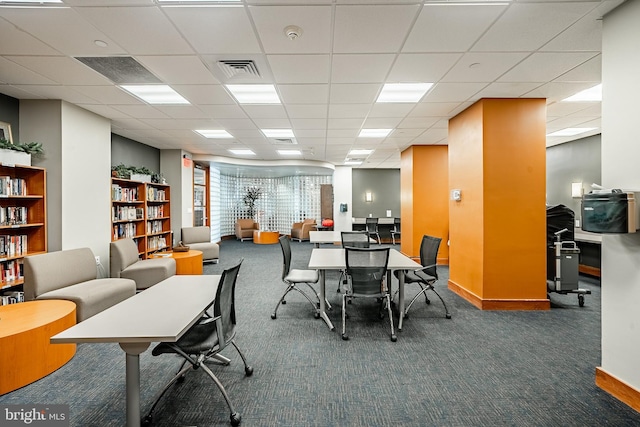 carpeted office featuring a drop ceiling