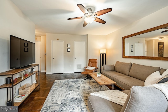 living room featuring dark hardwood / wood-style flooring and ceiling fan