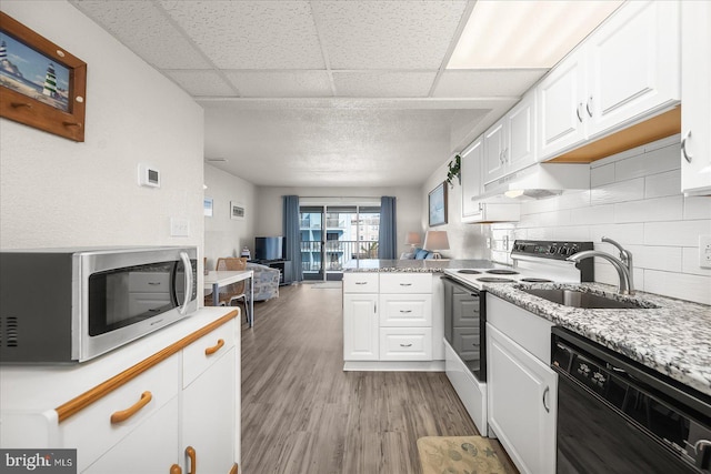 kitchen with light hardwood / wood-style floors, white cabinetry, white range with electric stovetop, and black dishwasher