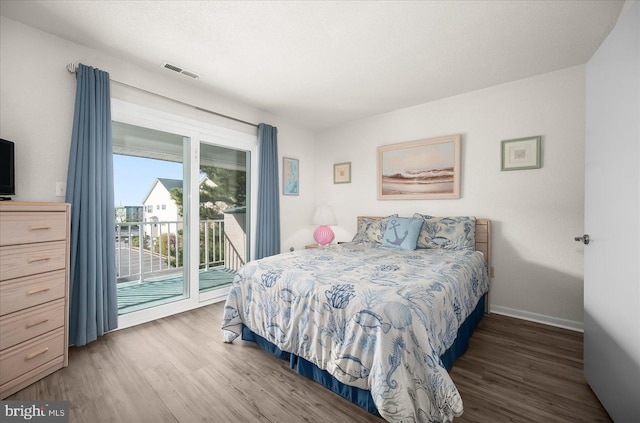 bedroom featuring access to outside and dark hardwood / wood-style floors