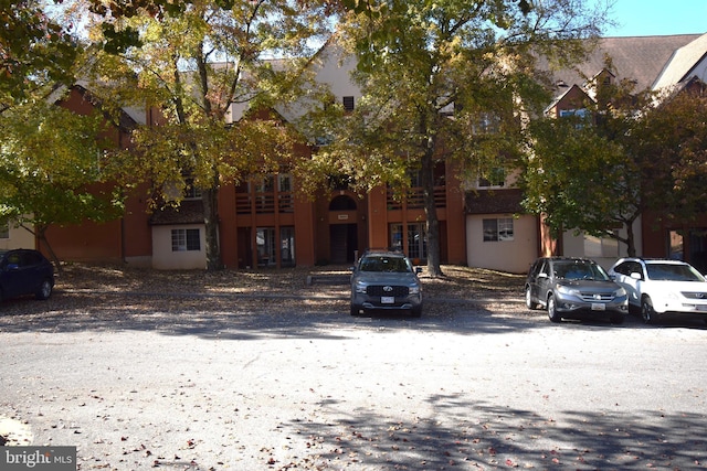 view of front of home with uncovered parking and stucco siding
