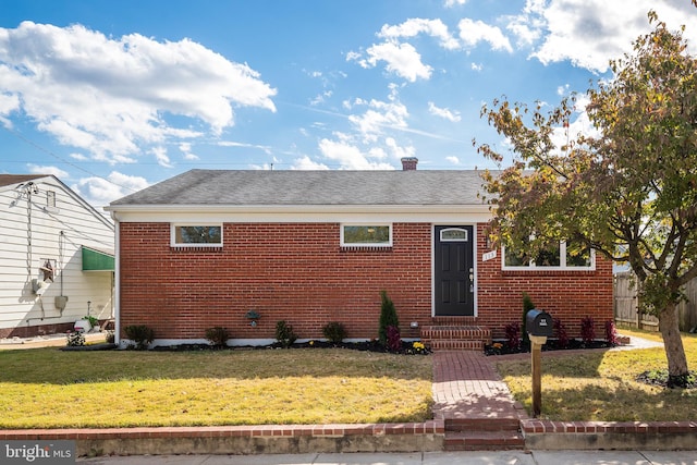 bungalow-style home with a front lawn