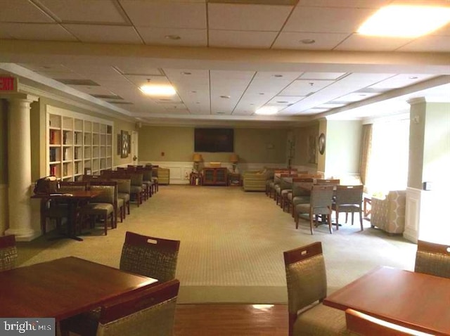 dining area featuring a paneled ceiling and carpet