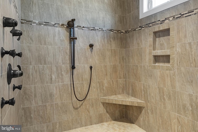 bathroom with tiled shower